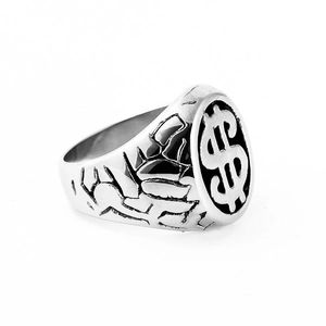 Detail view of gothic stainless steel dollar sign ring with vintage rock textures