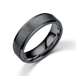 Macro view of black titanium steel ring featuring frosted surface and polished inner edge