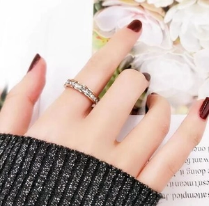 Close-up of rose gold eternity ring with sparkling cubic zirconia on a female finger