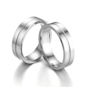 Detailed view of polished stainless steel couple rings with central groove design
