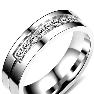 Macro detail of polished stainless steel band with nine channel-set sparkling zircons