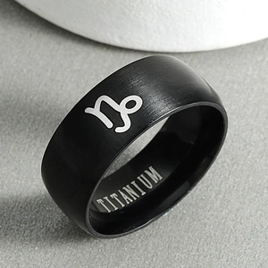 Macro shot of matte black titanium Capricorn ring showing inner metal engraving