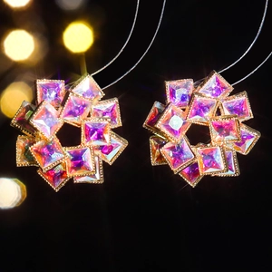 Macro shot of sparkling purple zircon flower earrings with iridescent crystal petals
