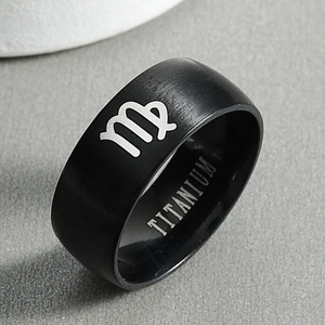 Macro shot of black titanium Virgo ring featuring brushed finish and silver constellation