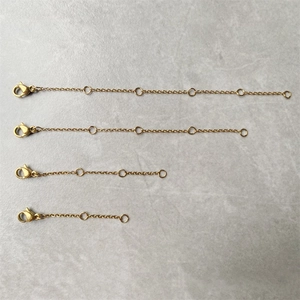 Macro shot of gold stainless steel extension chains in four lengths with lobster clasps