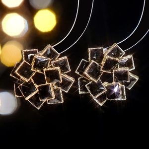 Elegant floral cluster stud earrings with black crystals and gold metal detailing