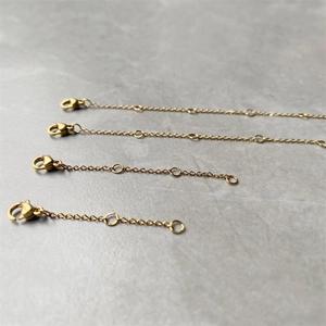 Detailed view of gold stainless steel extender chains with lobster clasps for jewelry DIY