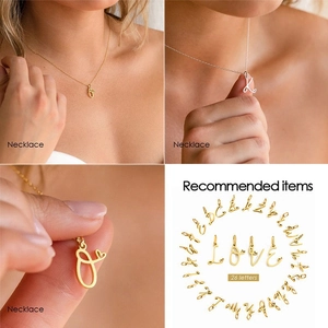 Minimalist stainless steel cursive letter pendant necklace with small heart details in gold