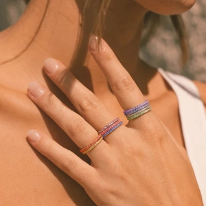 Close-up of colorful rhinestone stacking rings with 14K gold plated stainless steel bands