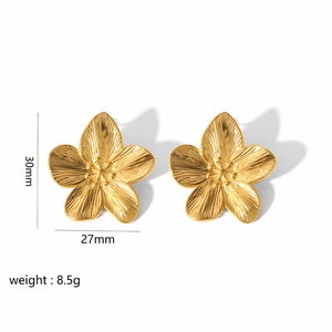 Detailed view of large gold floral earrings with 30mm size dimensions and brushed metal texture