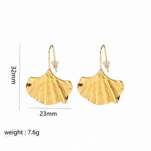 Macro detail of 18K gold ginkgo leaf earrings showing 32mm by 23mm dimensions