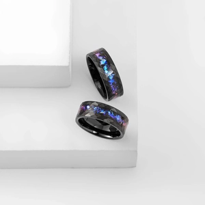 Polished black tungsten ring with faceted texture and purple blue opal inlay on stone