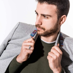 Mens minimalist silver titanium steel ring shown on hand with grey blazer outfit