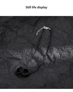 Minimalist black necklace featuring double interlocking rings on a sleek cord
