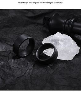Detailed view of matte black minimalist ceramic rings on elegant chess background