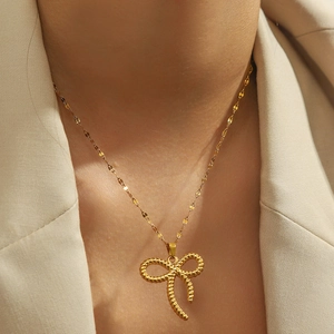 Elegant gold-tone stainless steel bow pendant necklace on a female neck model