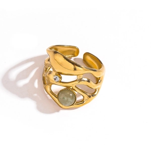 Detail of vintage gold open ring with large green gemstone and small zircon stone