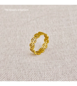 Detail shot of golden snake year ring featuring hollow ancient coin design motifs