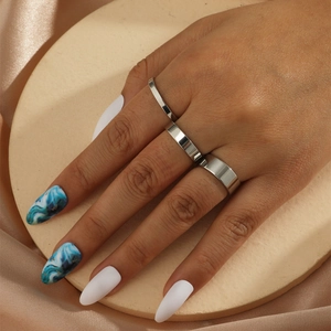 Three-piece silver minimalist stacking rings set for women shown on a model hand