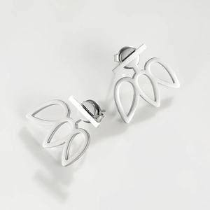 Macro shot of silver stainless steel minimalist flower stud earrings with a hollow leaf design