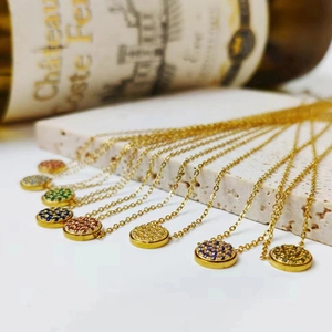 Detailed close-up of colorful round zircon pendants on golden stainless steel chain