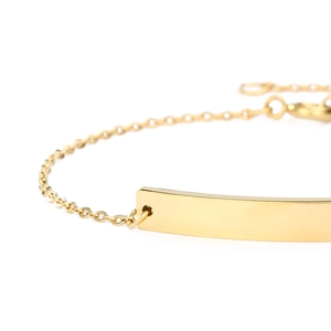 Detailed close-up of polished gold-plated stainless steel ID bar and delicate link chain
