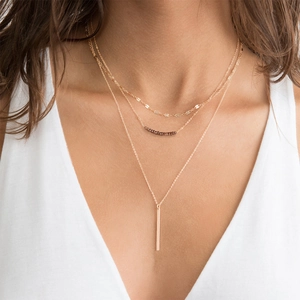 Three-layer gold stainless steel necklace with sequins, brown beads, and bar pendant