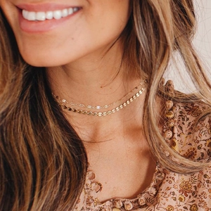 Double-layered 14K gold plated stainless steel chain necklace with sequin charms on model