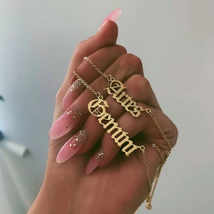 Detailed macro of gold-plated gothic Aries and Gemini constellation necklaces