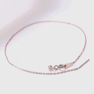 Detail of rose gold adjustable chain bracelet with needle pin and crystal charm