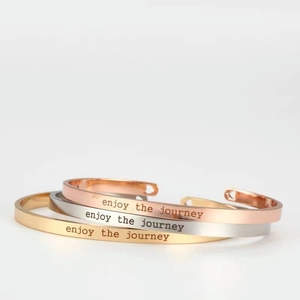 Polished stainless steel C-shape open bangles in gold, silver, and rose gold with engraving