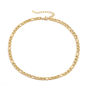Close-up of golden Figaro chain necklace with lobster clasp and adjustable extension link