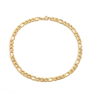Detail shot of the golden Figaro link chain necklace with a secure lobster clasp closure