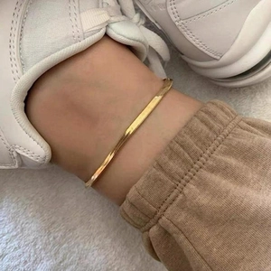 Minimalist 4mm gold plated flat snake chain anklet for women on a model ankle