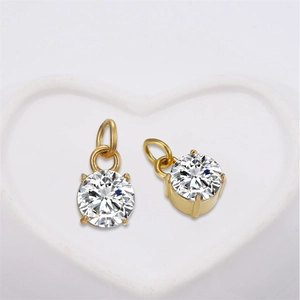 Classic round clear crystal pendants in four-prong gold setting on heart dish