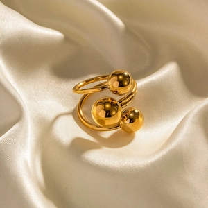 Detail of gold-plated brass ring featuring multi-layer band and polished beads