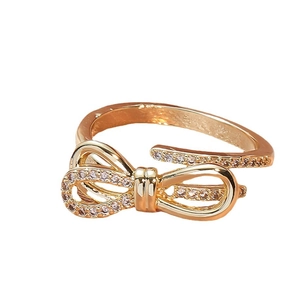 Sparkling bow-knot ring in gold finish with micro-paved diamonds and adjustable band
