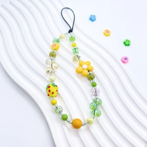 Handmade beaded phone strap with bright yellow fruit charms and floral acrylic beads
