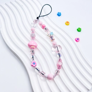 Detail of pink beaded phone charm with mushroom, heart, and floral resin beads