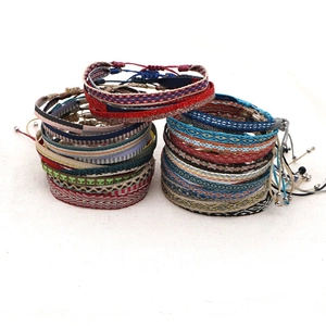 Detail of colorful bohemian handmade woven bracelets with ethnic geometric patterns