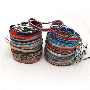 Close-up of Bohemian woven friendship bracelets with diverse geometric patterns and beads