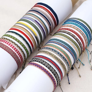 Bohemian hand-woven fabric bracelets with geometric patterns and ethnic tassel cords