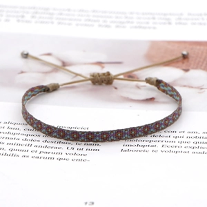 Detailed view of handmade bohemian woven bracelet with adjustable cord and geometric pattern
