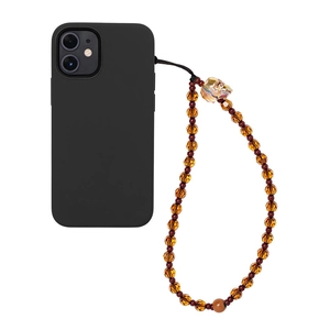 Amber crystal phone charm strap with skull bead and orange accents on smartphone