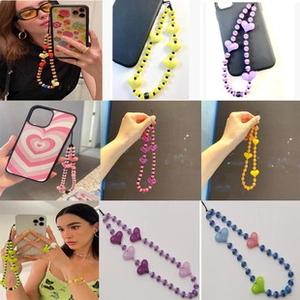 Detail view of colorful beaded phone straps featuring heart charms in various vibrant colors