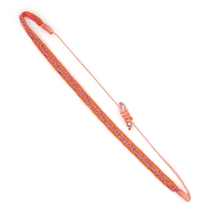 Detail of bohemian handwoven orange bracelet with adjustable sliding knot and silver beads