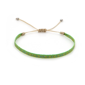 Detail of hand-woven bright green friendship bracelet with blue and gold geometric patterns