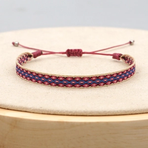 Detail of bohemian handwoven bracelet with geometric patterns and adjustable cord