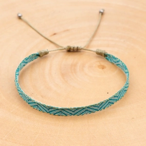 Detail of hand-woven bohemian bracelet with V-pattern and adjustable sliding knot