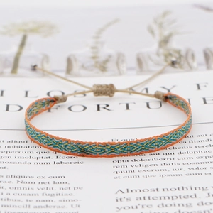 Macro shot of Bohemian woven friendship bracelet with ethnic patterns and sliding knot